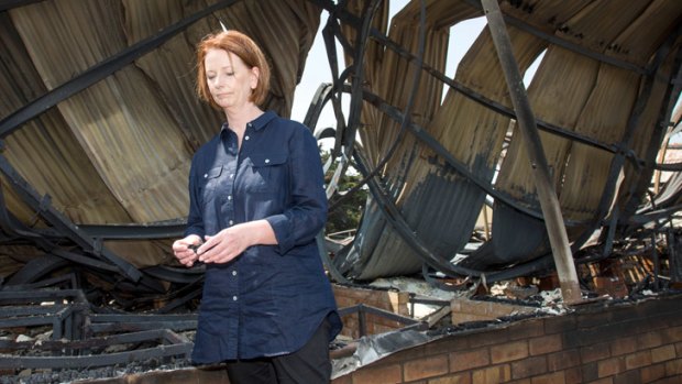 Prime Minister Julia Gillard inspects the ruins of  Dunalley Primary School in Tasmania, where bushfires have destroyed about 100 buildings.