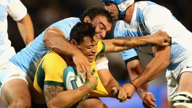 Stranglehold: Israel Folau is tackled during the Wallabies' upset loss to the Pumas. 