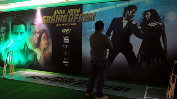 A Pakistani visitor looks at posters of the forthcoming Pakistani film "Main houn Afridi" or "I am Afridi" in Karachi on July 7, 2013. The Pakistani film inspired by the fairytale career of cricket star Shahid Afridi goes on release next month, a heart-warming tale of raw talent that producers believe will be a smash hit.