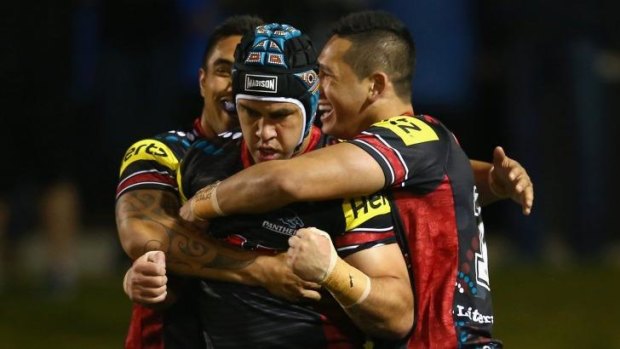 Success story: Jamie Soward and Panthers teammates celebrate a try against the Cowboys.