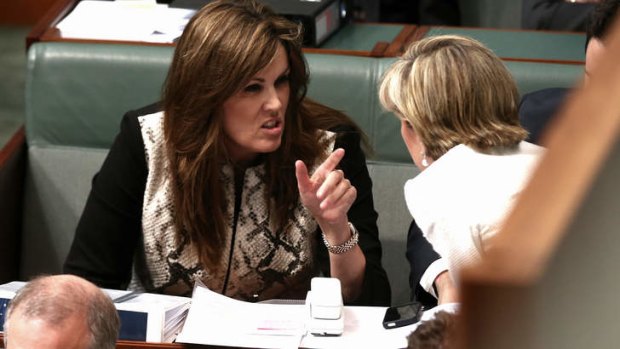 Tony Abbott's chief of staff Peta Credlin talks to Foreign Minister Julie Bishop during question time in Parliament on Monday.
