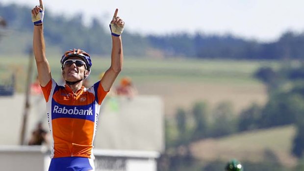 Rabobank rider Luis Leon Sanchez of Spain (L) celebrates winning the ninth stage as new race leader Thomas Voeckler of France looms in the background.