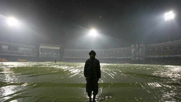 A security guard stands on the rain-soaked R Premadasa Stadium in Colombo, where Australia's match against Sri Lanka was washed out.