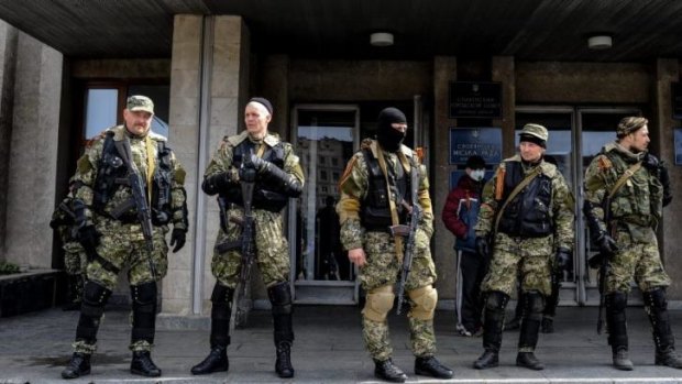 Armed pro-Russian activists stand outside the Ukrainian regional administration building in the eastern Ukrainian town of Sloviansk.  
