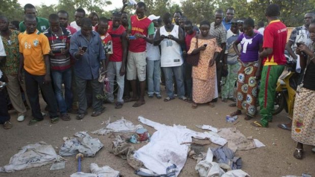 Disarray: People look at bloodied clothes found in a house belonging to Francois Compaore, the younger brother of deposed president Blaise Compaore, in Ouagadougou, the capital of Burkina Faso.