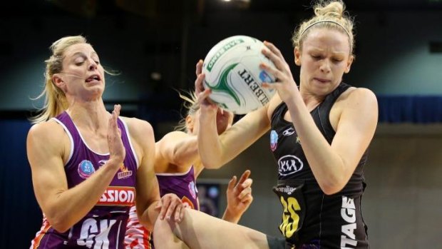 Jo Harten of the Magic (right) and Laura Geitz of the Firebirds compete for the ball.