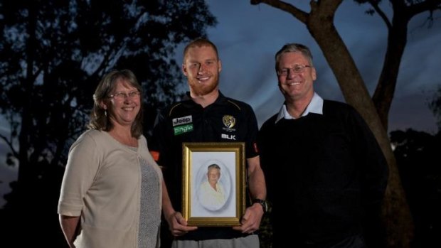 Three generations: Richmond's Nick Vlastuin holds a photo of his grandfather, Len or 'Opa', flanked by his parents.