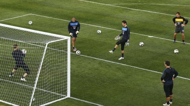 Friendly fire ... Adam Federici, centre, and Brad Jones sharpen first-choice keeper Mark Schwarzer's reflexes at Socceroos training in South Africa.