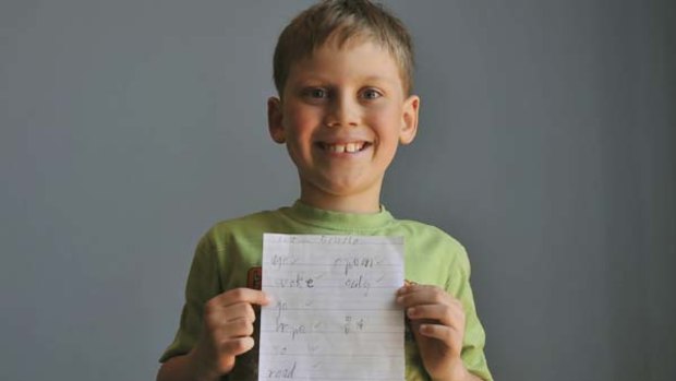 Liam Garbellini proudly dsiplays his spelling test.