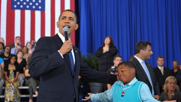 US President Barack Obama chats with Tyren Scott, 9, of Paulina, Louisiana, during a town hall meeting at the University of New Orleans in New Orleans.