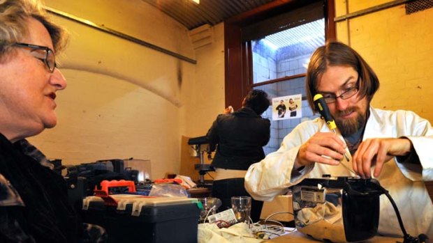 Burnt out: Jason Bond, right, repairs Barbara Olney's toaster.