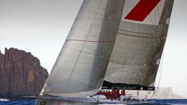 Super-maxi Wild Oats XI, which, along with British entrant Ran, is subject to race committee protests, sails past the Organ Pipes on the way to Hobart.