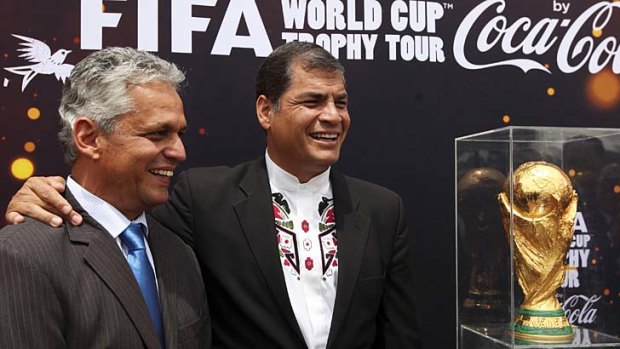 Ecuador's president Rafael Correa (centre) poses with soccer coach Reinaldo Rueda next to the World Cup trophy, during a ceremony at Carondelet Palace in Quito on Monday. The Cup is on a world tour ahead of the tournament in Brazil.
