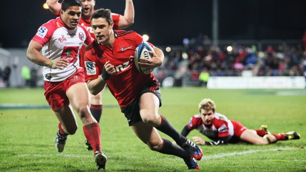 Dan Carter of the Crusaders scores a try against Queensland at AMI Stadium in Christchurch.