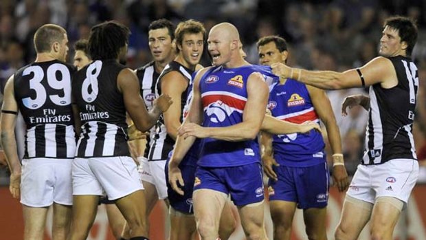 Collingwood players get intense with Barry Hall as Leigh Brown tries to hold the Western Bulldogs player back.