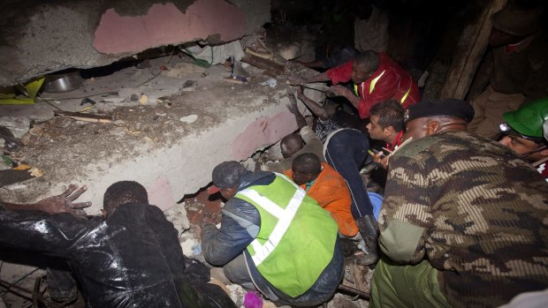 Rescue workers search for survivors at the site of a building collapse in Nairobi, Kenya.