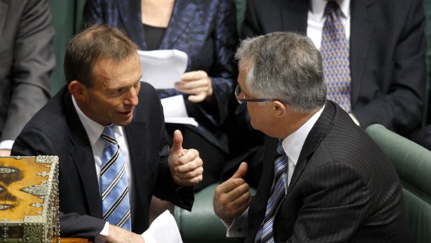 Opposition Leader Malcolm Turnbull speaks to fronchbencher Tony Abbott in Parliament today.