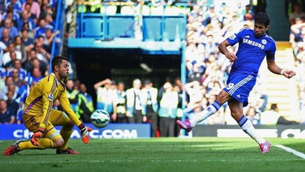 Diego Costa of Chelsea shoots past Lukasz Fabianski of Swansea City to complete his hat-trick.