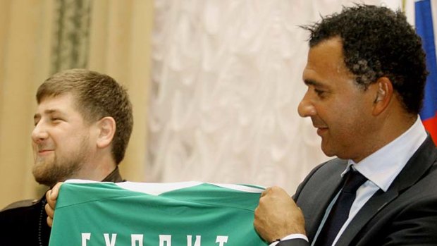 Chechen President Ramzan Kadyrov hands Ruud Gullit his team's jersey. It would prove a poisoned chalice.