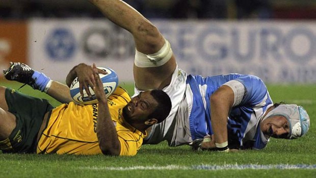 Class act ... Kurtley Beale is tackled by Patricio Albacete.