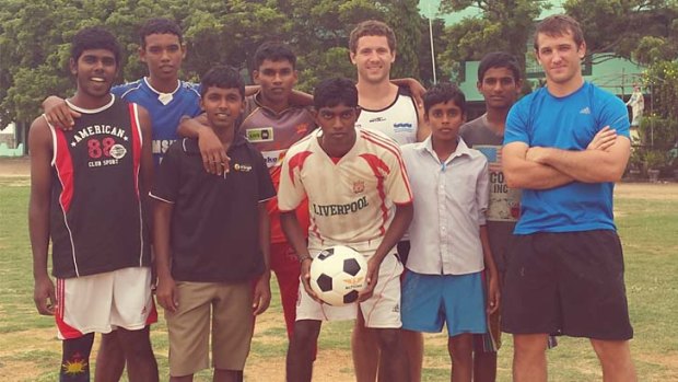 On the ball: The author tries his hand at football during his time in Sri Lanka.