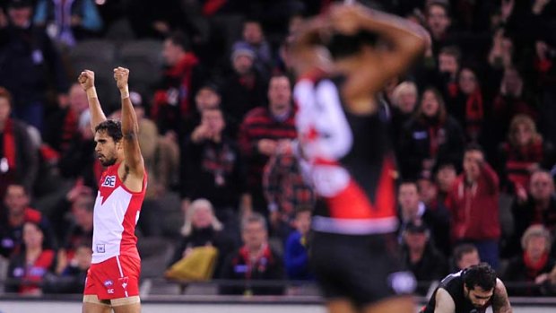 Sydney's Lewis Jetta celebrates while Essendon's Courtenay Dempsey ponders what could have been.