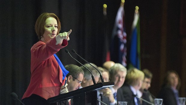 Prime Minister Julia Gillard calls for questions from a person attending a community cabinet meeting at Redbank Plains State High School on July 10, 2012.