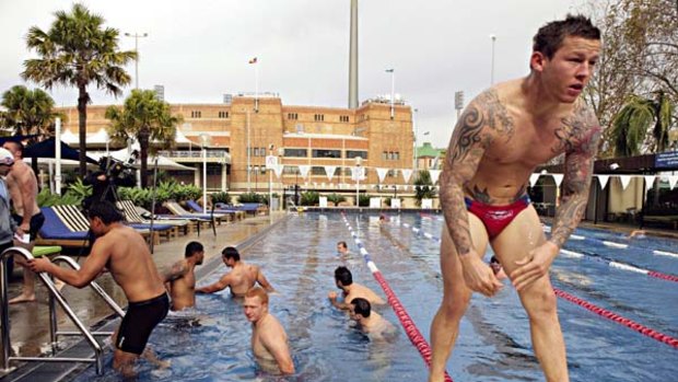 Recovery ... Todd Carney and his Roosters teammates hit the pool at the Sydney Football Stadium yesterday.