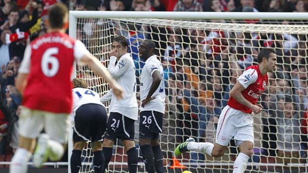 Arsenal's Robin van Persie (right) scores against Tottenham Hotspur.