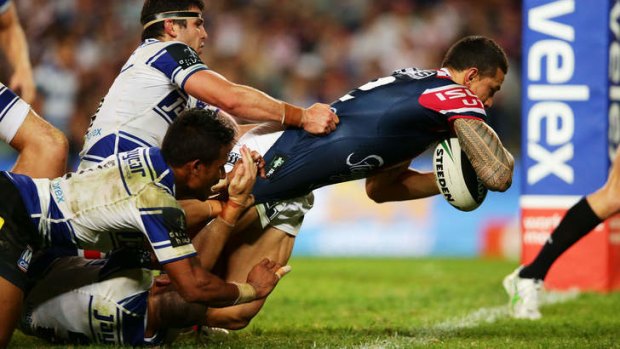Sonny Bill Williams of the Roosters charges over the line to score his second try.