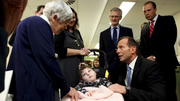 Opposition Leader Tony Abbott talks to Sister Kathleen Munce  from the Sisters of Charity and Lara Dunn at St Vincent's Hospital.