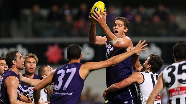 Giant among men: Docker Aaron Sandilands looks for an option after gathering the ball amid a ring of Fremantle and Collingwood players.