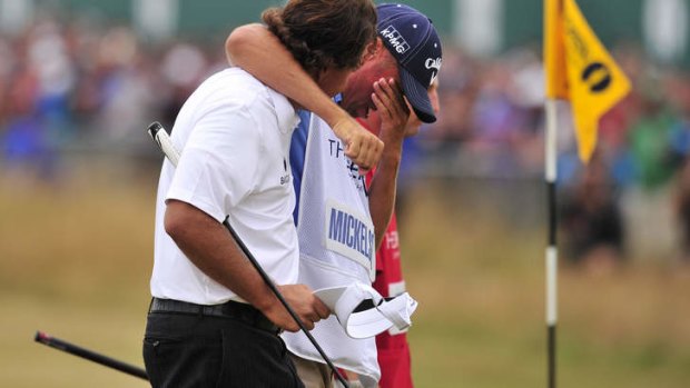 Tearful embrace: Phil Mickelson hugs his caddie Jim Mackay.