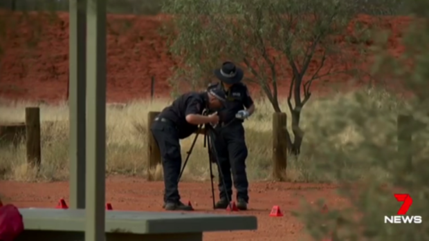 Police investigate at the scene of a stabbing death in the Northern Territory. 