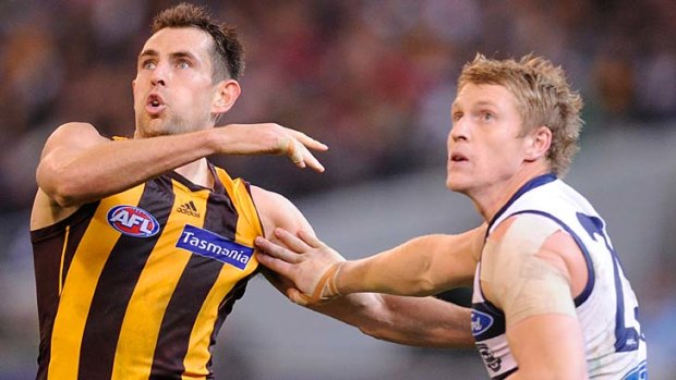 Hawthorn's Luke Hodge battles with Geelong's Josh Caddy back in round 15.