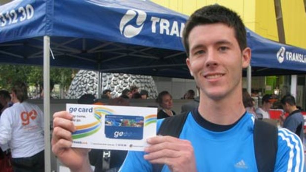 Wishart commuter Jono Webb picks up his free Go Card from one of Translink’s 10 public giveaway events.