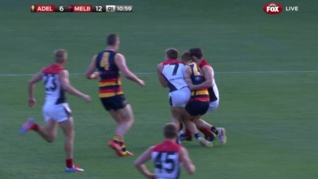 Melbourne's Jack Viney (middle, number 7) collides with Tom Lynch and Alex Georgiou on Saturday.