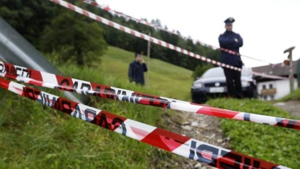Italian police officers cordon off the site where the car accident occurred.