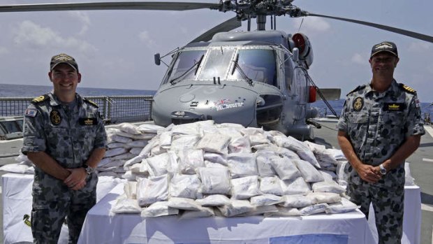 Crew members of HMAS Melbourne with seized drugs prior to them being destroyed.