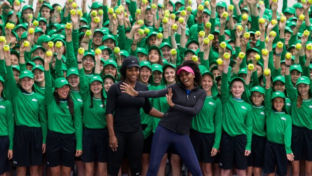 Serena and Venus Williams with the Open's 380 ballkids.