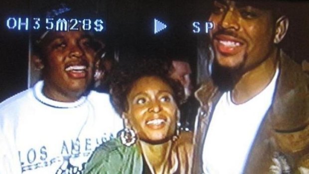 Dee Barnes with Dr Dre (L) and The D.O.C. (R) before Dre assaulted Barnes.