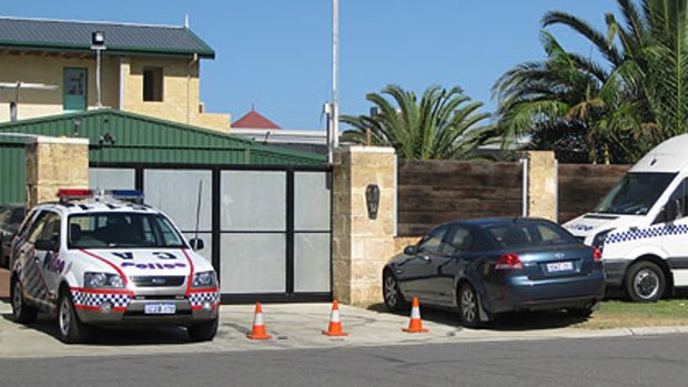 Police cars line up outside the highly-fortified Coffin Cheaters clubhouse.