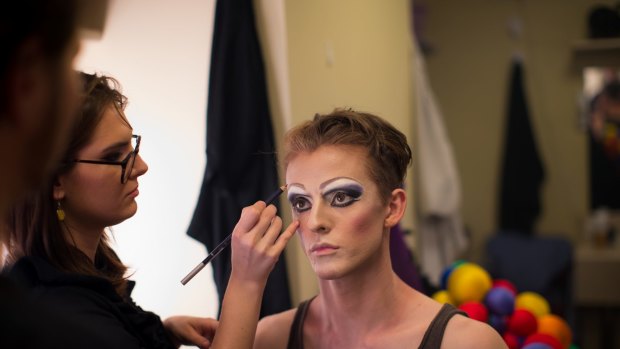 The finishing touches are applied to Adam Noviello's eye make-up.