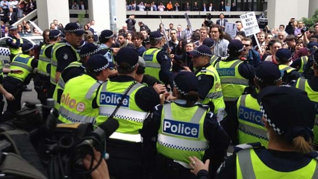 Students face off against police.