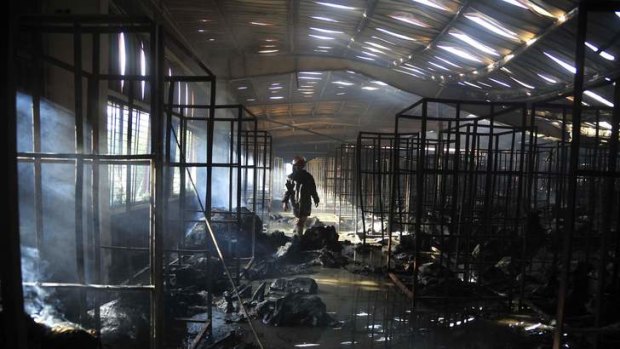 A firefighter inspects a burnt garment factory after a fire in the Bangladeshi town of Gazipur.