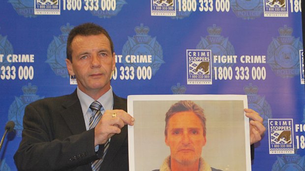 Detective Inspector Dave Bryson holds up a photo of Garry Edmund Brown who was taken into custody in relation to a double murder in Maylands earlier this morning.