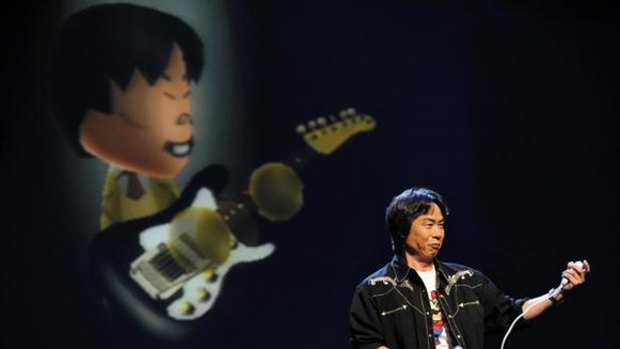 Legendary game designer Shigeru Miyamoto demonstrates the new game, Wii Music, by playing virtual guitar during the Nintendo E3 media briefing in Los Angeles.