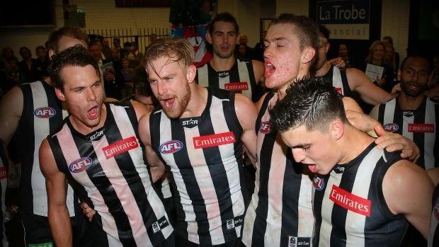 MELBOURNE, AUSTRALIA - AUGUST 08: Matt Scharenberg, Jonathon Marsh, Darcy Moore and Brayden Maynard of the Magpies sing the song in the rooms after winning the round 19 AFL match between the Collingwood Magpies and Carlton Blues at Melbourne Cricket Ground on August 8, 2015 in Melbourne, Australia.  (Photo by Quinn Rooney/Getty Images)