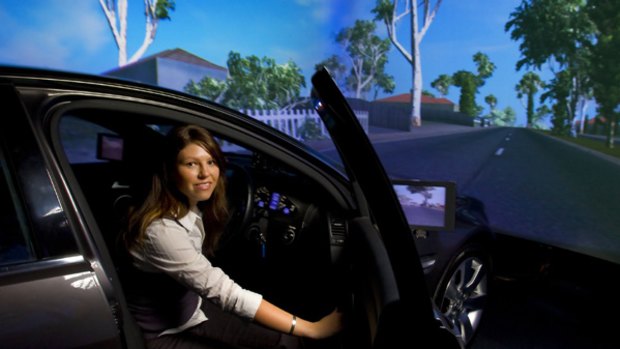 Kristie Young, who researches car crashes at Monash University, in the advanced driving simulator.