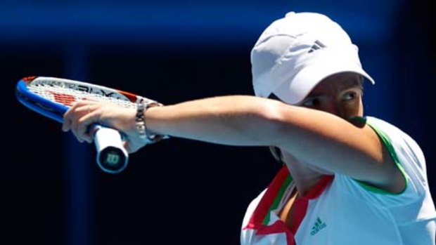 Third-round loss ... Justine Henin feels the heat in Melbourne.